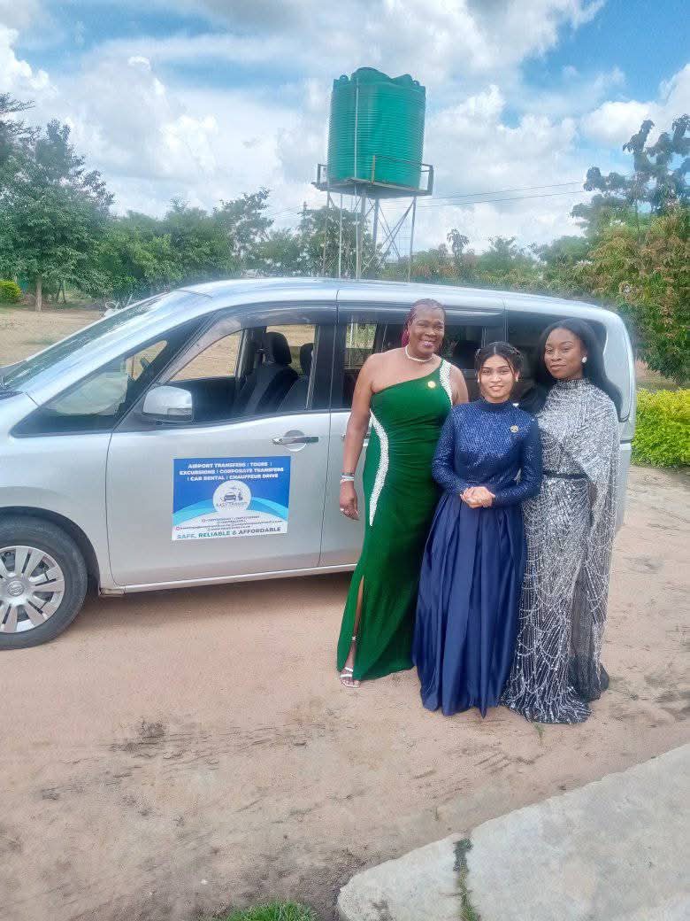 Tourists enjoying a scenic viewpoint with a luxury vehicle